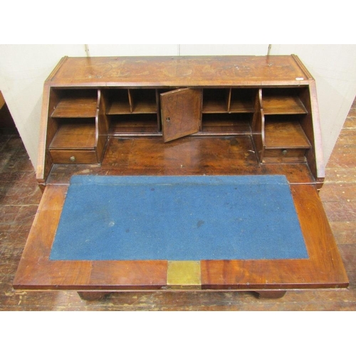 1548 - An 18th century walnut writing bureau,the front elevation enclosed by two long and two short drawers... 