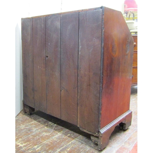 1548 - An 18th century walnut writing bureau,the front elevation enclosed by two long and two short drawers... 