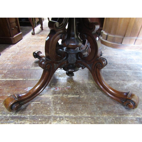 1551 - An early Victorian rosewood loo table,the top of oval form with carved and repeating floral borders ... 