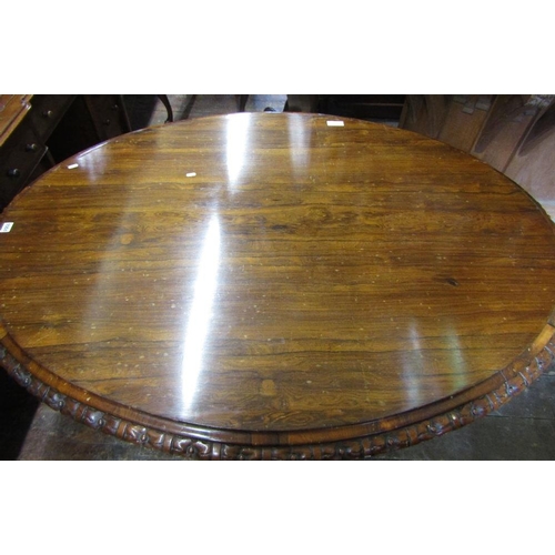 1551 - An early Victorian rosewood loo table,the top of oval form with carved and repeating floral borders ... 