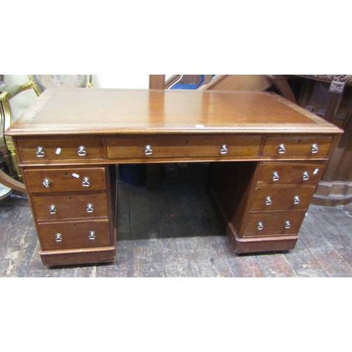 1555 - A Victorian mahogany pedestal writing desk fitted with nine frieze drawers with inset top,140 cm wid... 