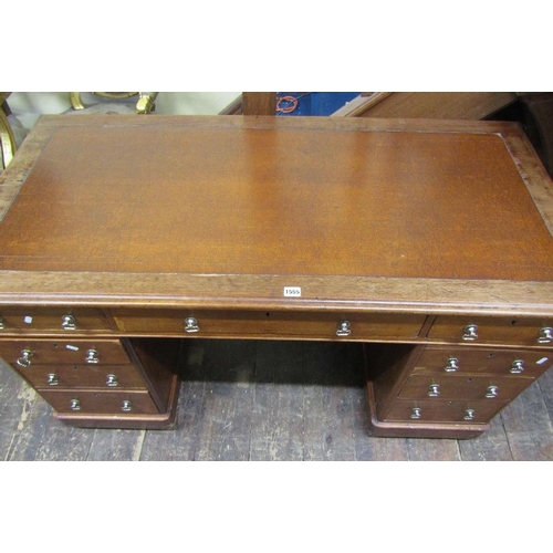 1555 - A Victorian mahogany pedestal writing desk fitted with nine frieze drawers with inset top,140 cm wid... 