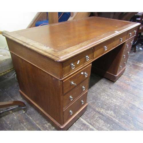 1555 - A Victorian mahogany pedestal writing desk fitted with nine frieze drawers with inset top,140 cm wid... 