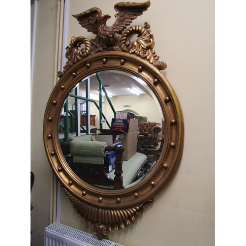 1557 - A substantial gilded wall mirror in the Regency style,the circular bevelled edge mirror plate within... 