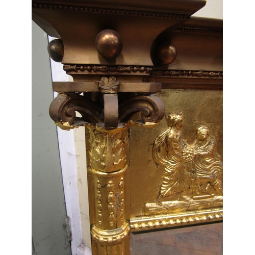 1564 - A Regency three pane overmantle mirror with bevelled edge plate,beneath a classical frieze showing a... 