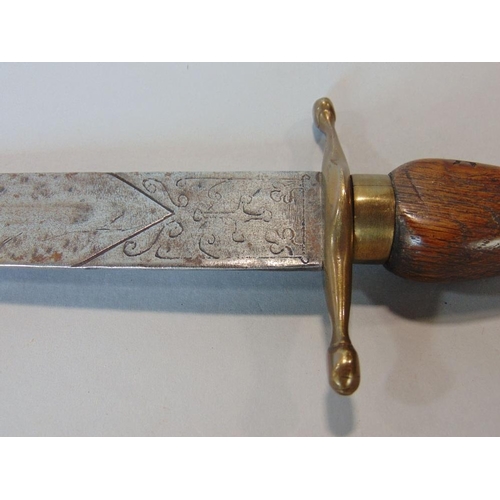 624 - A socket bayonet with brass guard and tapering oak grip