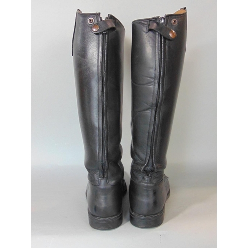 634 - A pair of black leather riding boots in good condition by Soubirac UK size 4.5,in associated boot ba... 