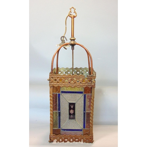 645 - A Victorian brass framed hall lantern,with pierced borders and enclosing geometric leaded light pane... 