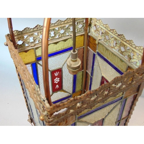 645 - A Victorian brass framed hall lantern,with pierced borders and enclosing geometric leaded light pane... 