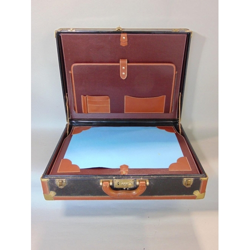 647 - A brief case with tan coloured leather borders,black panels and brass fittings