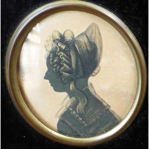 663 - Two early 19th century silhouette profile portrait miniatures,both of oval form,one showing a lady i... 