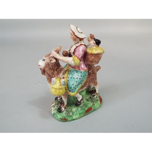 68 - A 19th century Staffordshire figure group of the tailor~s wife riding on a goat,after the Meissen mo... 