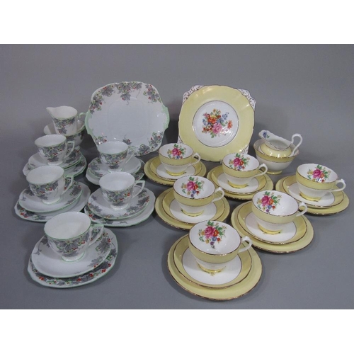 77 - A collection of New Chelsea Staffordshire floral teawares with yellow border decoration,comprising m... 