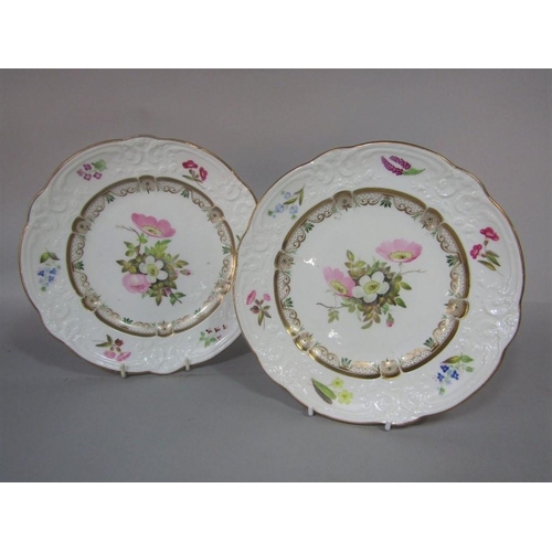 83 - A pair of early 19th century Nantgarw dessert plates,with relief moulded borders and painted floral ... 