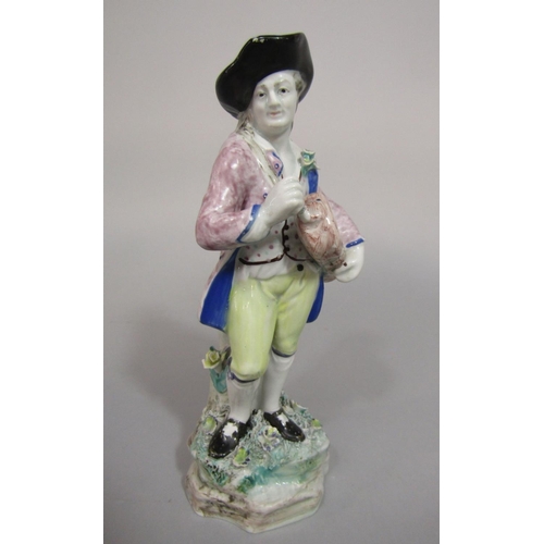 91 - An early 19th century hollow cast pottery model of a hurdy-gurdy player in 18th century style costum... 