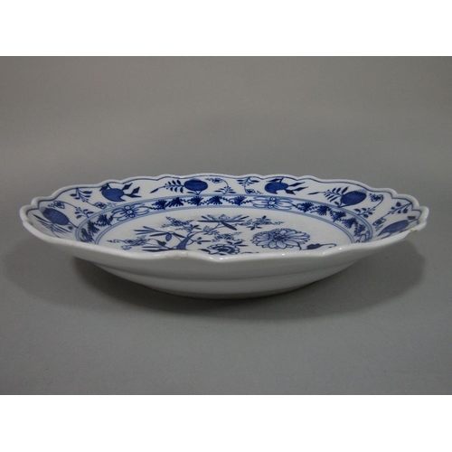 94 - A 19th century Meissen type charger with blue and white painted floral decoration with blue cross sw... 