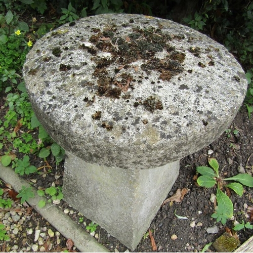 142 - A matched pair of small weathered reconstituted saddlestones, 50cm high approx