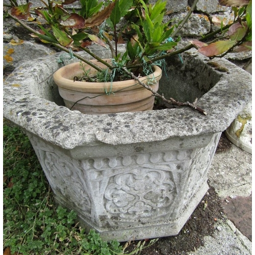 144 - A weathered reconstituted planter of octagonal form of geometric detail, 50cm diameter