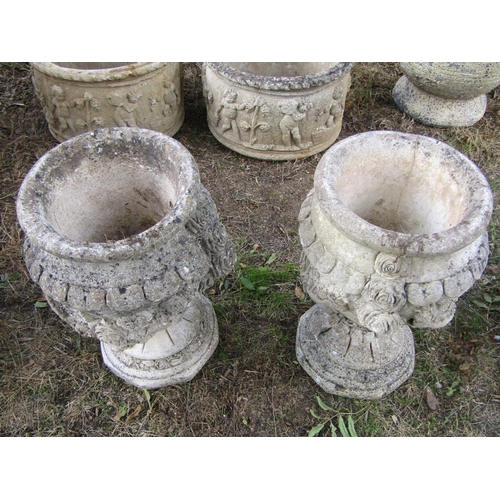 90 - A pair of weathered urns with trailing floral detail, 65cm diameter