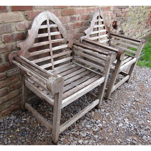 163 - A pair of weathered teak garden chairs in the manner of Lutyens,