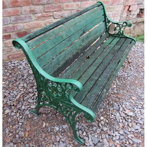 164 - A small cast iron garden seat with flower head motif detail, painted, 130cm long