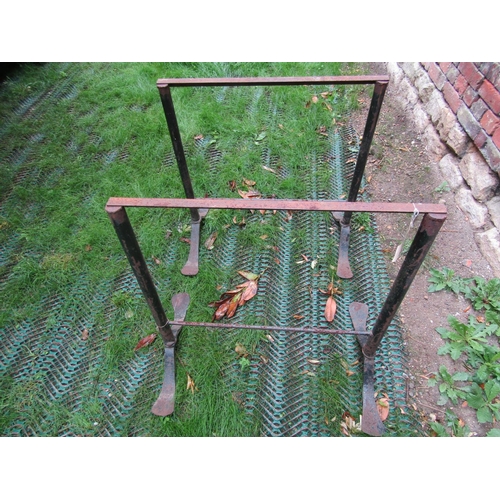 174 - A pair of adjustable iron frames on swept supports, 80cm wide