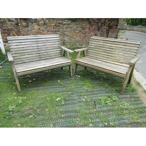 203 - A pair of weathered pine slatted garden benches by Riverco, 130cm long