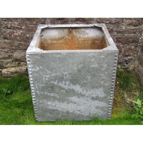 183 - A galvanised iron water tank of cubic form with riveted detail, 62cm square