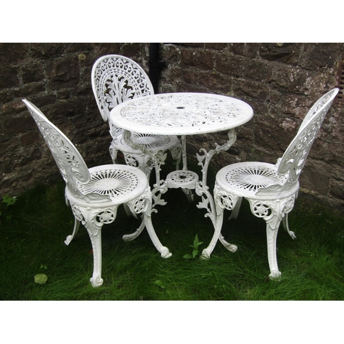 187 - A decorative cast aluminium terrace table of circular form, together with three chairs