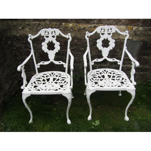 189 - A set of four decorative cast aluminium garden armchairs with floral swag detail