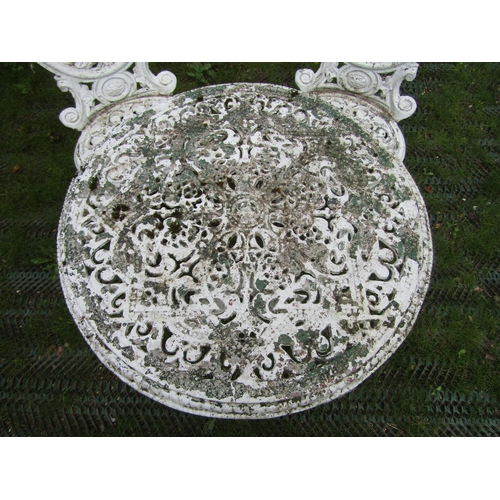 202 - A small decorative cast aluminium terrace table and two matching chairs, the table 60cm diameter