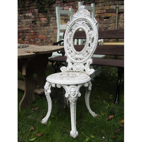 202 - A small decorative cast aluminium terrace table and two matching chairs, the table 60cm diameter