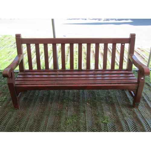 206 - A sturdy teak wood garden bench with scrolled arms, 182cm long