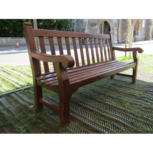 206 - A sturdy teak wood garden bench with scrolled arms, 182cm long