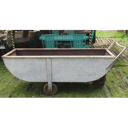 1668 - A vintage agricultural galvanised steel three wheeled feed barrow with six feet long body approx exc... 