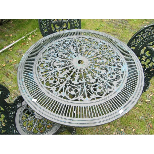 1672 - A green painted aluminium garden terrace table of circular form with decorative pierced detail, toge... 