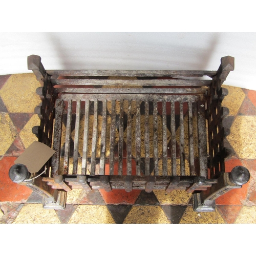 1696 - A cast iron fire basket of rectangular form with lattice surround and urn shaped finials, 54 cm wide... 