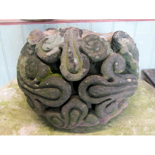 1708 - A weathered natural stone corbel with deep carved scrolling foliate detail, 38 cm in diameter approx