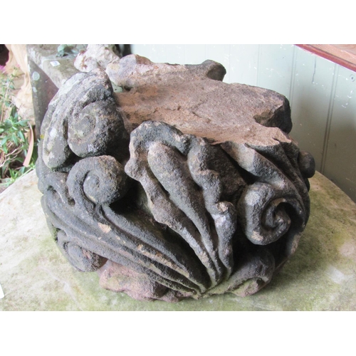 1708 - A weathered natural stone corbel with deep carved scrolling foliate detail, 38 cm in diameter approx