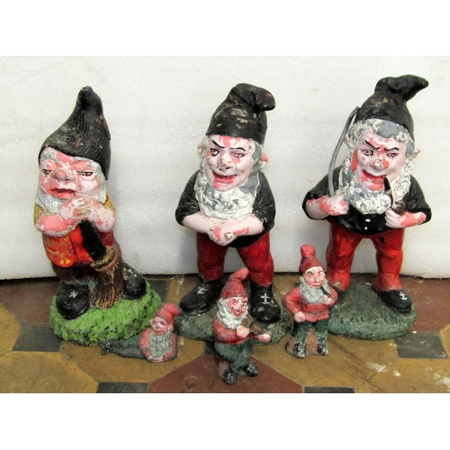 1722 - Three small cast composition stone garden gnomes in varying poses with brightly painted weathered fi... 