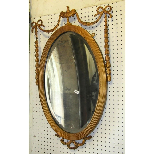 1745 - A shield shaped wall mirror, the scrolling gilt moulded and acanthus frame with raised flower and ba... 