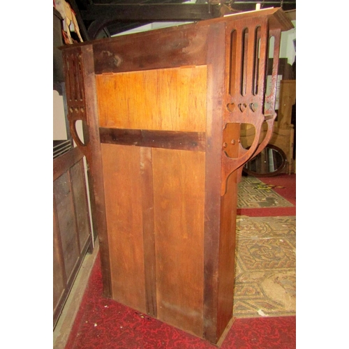 1766 - An Art Nouveau/crafts oak bookcase, enclosed by a pair of rectangular leaded light panelled doors, b... 