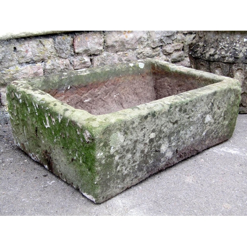 1715 - A weathered natural stone trough of rectangular form 68 cm long x 47 cm wide x 23 cm deep