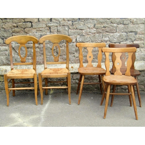 1806 - A set of seven vintage stained beechwood single chairs with simple rail backs over dished slatted se... 