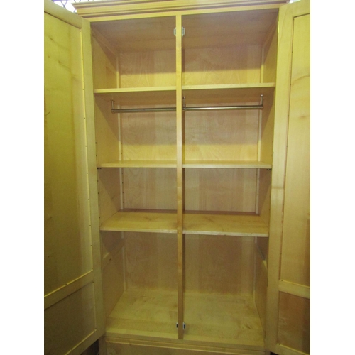 1830 - A good quality contemporary maple wardrobe enclosed by a pair of three quarter length fielded panell... 