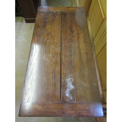 1831 - A good quality reproduction oak side table, the rectangular top with cleated ends over a frieze draw... 