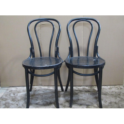 1841 - A set of four ebonised Bentwood cafe chairs with circular seats and slightly swept supports