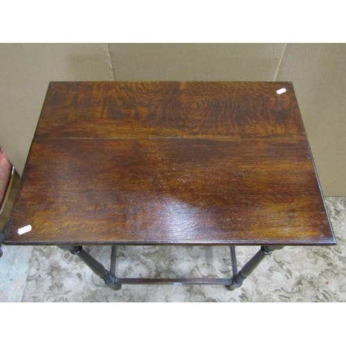 1851 - An old English style oak side table, the rectangular overhanging top raised on four slender turned s... 