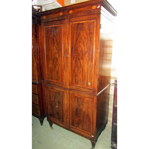 2012 - A Georgian mahogany linen press with crossbanding and further inlaid detail moulded cornice over a p... 