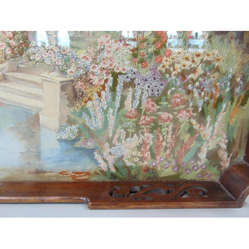 1231 - 2 hardwood gallery trays each with glass over embroidered and painted base, with bright colours and ... 